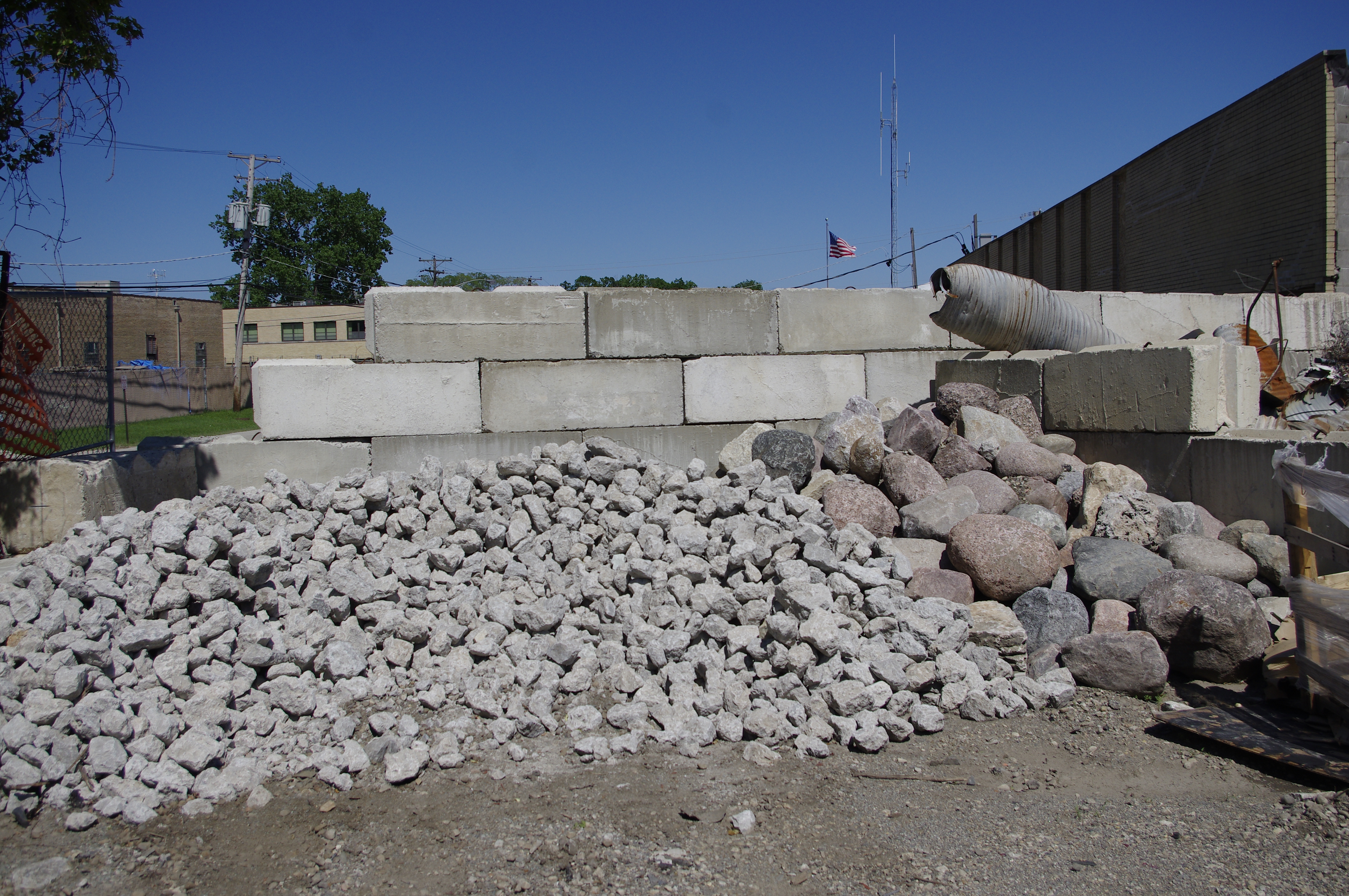 Close view of light-gray angular bulk rock in the DPMS material yard